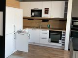 an image of a kitchen with white cabinets and black counter tops