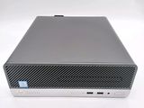 the back of a small computer with a keyboard on top of it