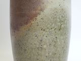 a close up of a vase on a white surface
