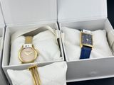 two watches in a white box with a blue strap and a gold watch