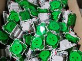 a box full of green and white buttons in it