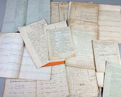 a pile of old papers that are on a table