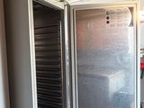 a refrigerator and freezer in a room with a lot of cabinets