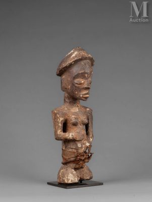 a wooden statue of a man with a hat on his head