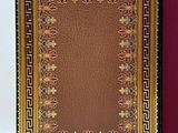 an image of a book with a red cover and a gold border