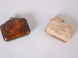 two small purses sitting next to each other on a table