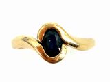 a close up of a gold ring with a blue stone