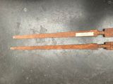 two old wooden knives sitting on top of a table