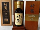 a bottle of whisky sitting on a table next to a box