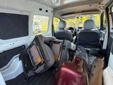une camionnette blanche avec des bagages à l'arrière