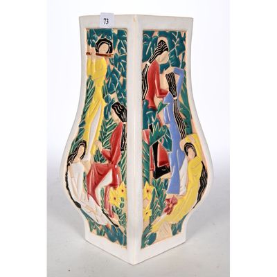 a vase with a painting on it sitting on a table