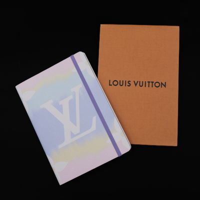 louis vuitton notebook and box on a black background