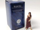 a figurine of a woman in a red dress next to a blue box