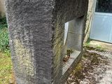 a concrete bench sitting in front of a building