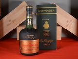 a bottle of courvoisier next to a box of wine
