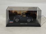 a small black car in a clear display case