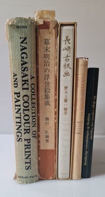 several books are stacked on top of each other on a table