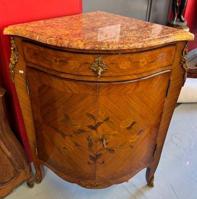 a small chest of drawers with a marble top