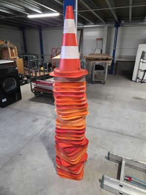 un grand cône orange surmonté d'une bande blanche