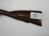 an old rifle with a wooden barrel and a tag on it