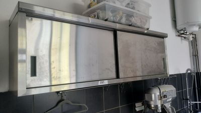 a kitchen with a sink and a mirror on the wall