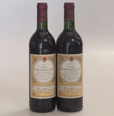 two bottles of wine sitting next to each other on a table