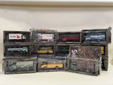 many different types of toy trains in boxes on a table