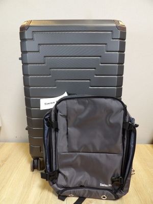 a black suitcase sitting on a wooden table next to a black suitcase