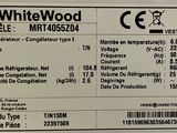 a label on the back of a white wood refrigerator