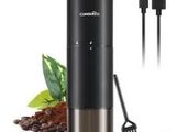 a close up of a coffee grinder with a cup of coffee next to it