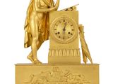 an image of a gold clock with a statue of a man holding a sword