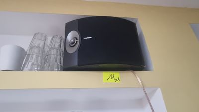 a black and white radio on a shelf in a kitchen