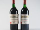 two bottles of red wine sitting next to each other on a white surface
