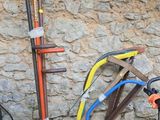 a scooter that is parked next to a stone wall
