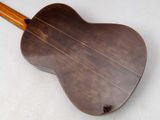 a close up of an acoustic guitar on a white surface