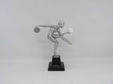 silver statue of a woman holding a tennis racket on a white surface