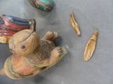 a small wooden figurine of a baby on a table