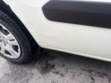 a white car with black trims parked in a parking lot