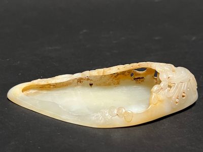 a small piece of white marble on a black surface