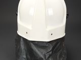 a white hard hat sitting on top of a black bag