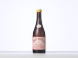 the bottle of wine is sitting on the table