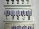 four white trays with six different sizes of switches on top of each other