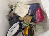 a white bag filled with assorted items and a pair of scissors