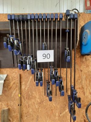 a lot of tools hanging on the wall in the garage