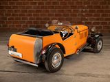 an orange toy car parked in front of a brick wall
