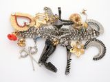 a lot of brooches that are laying on a white surface