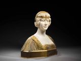 a white marble bust of a woman wearing a headdress