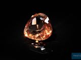 an orange diamond on a black surface