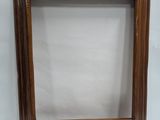a brown picture frame with a white background and a white wall