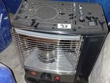 a small black heater sitting next to a blue trash can